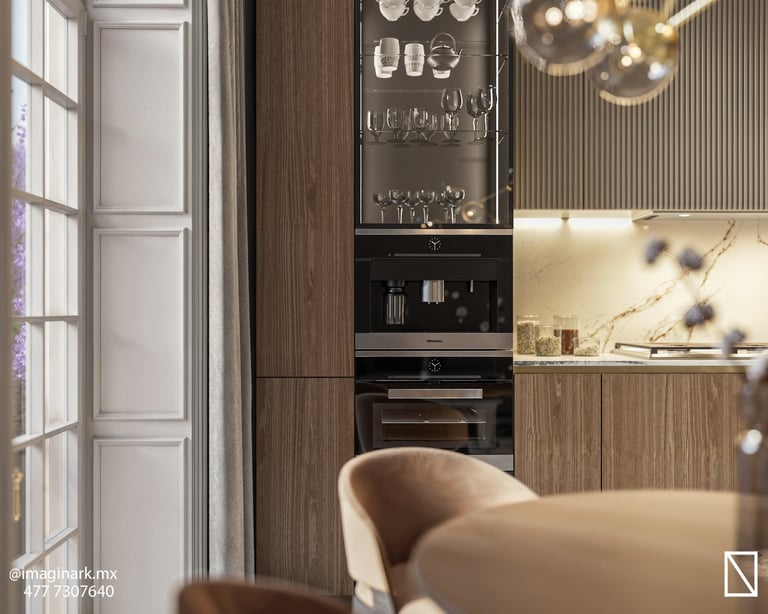 Cocina moderna con electrodomésticos negros empotrados y sillón beige