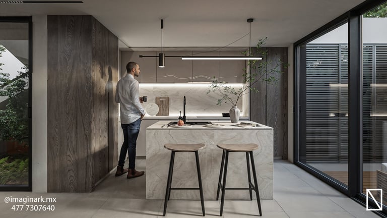 Cocina moderna con isla de mármol, taburetes y hombre junto al mobiliario oscuro